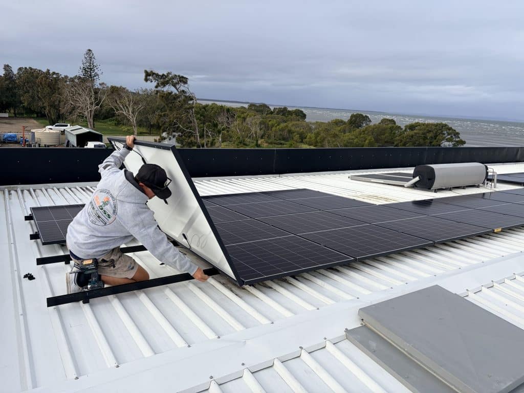 SEBSS installer fitting solar panels on a Colorbond roof