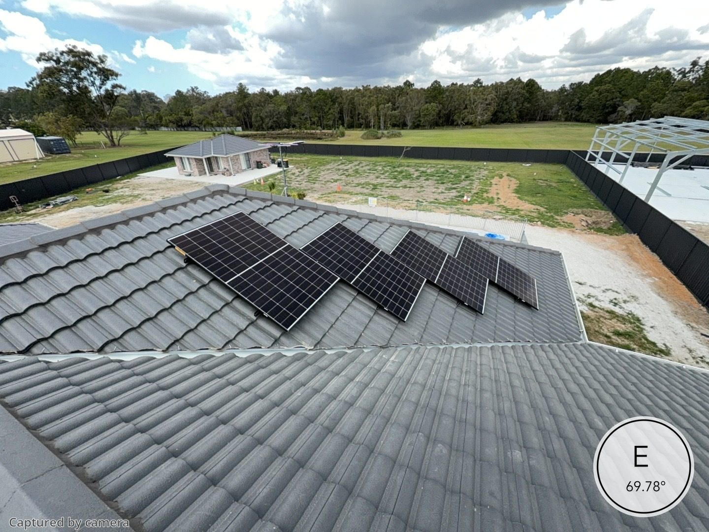 East facing solar panels installed on a grey tiled roof of a new home on an acreage block in Queensland